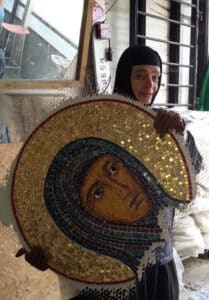 Sister Gabriela holding a mosaic